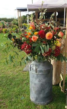 Red and orange milkchurn at Bridge House Barn Leicestershire wedding